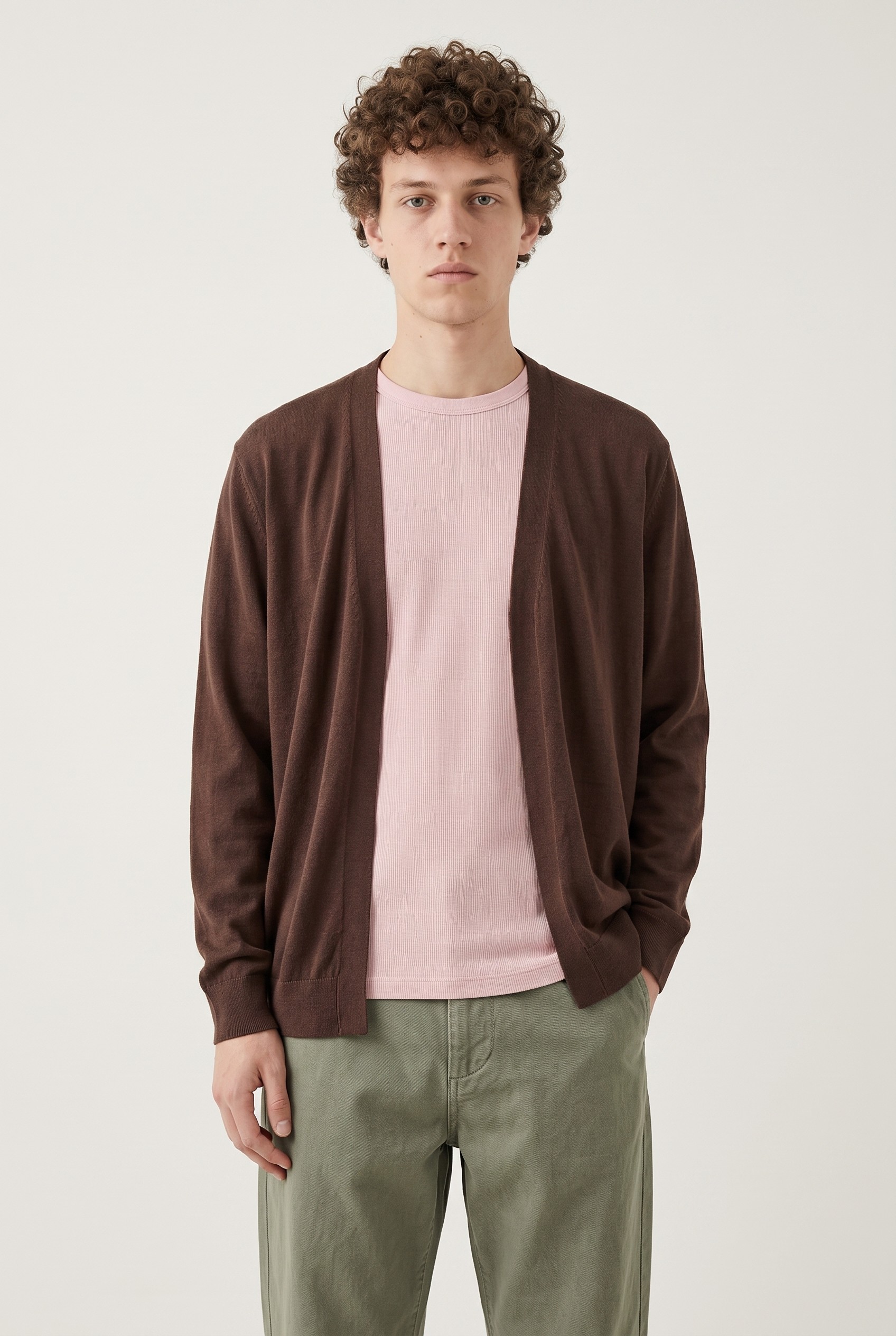 Model wearing a brown cardigan and green trousers