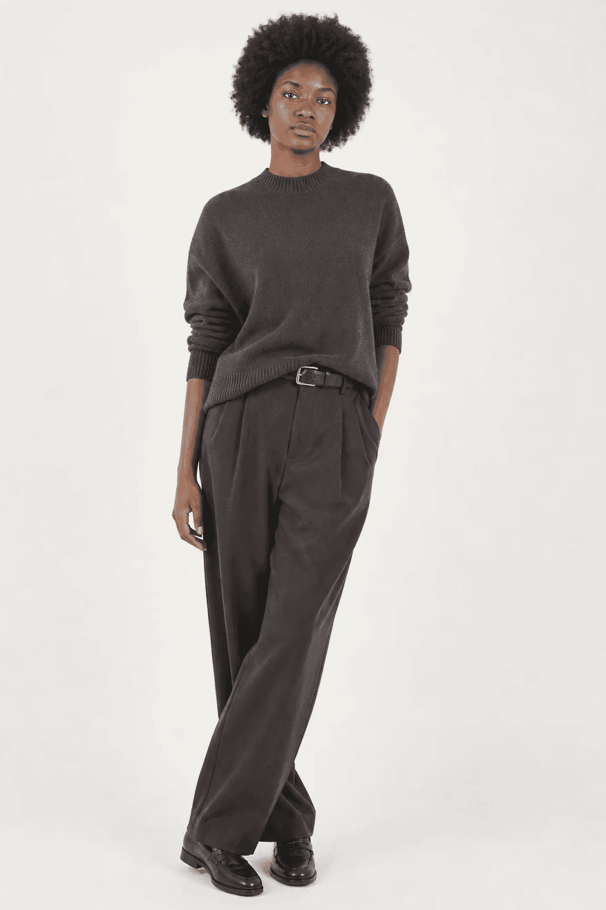 Model wearing a dark sweatshirt and trousers